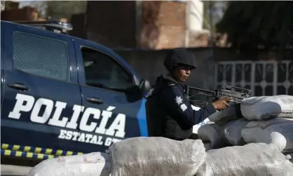  ?? Photograph: Rebecca Blackwell/AP ?? Local police in Guanajuato state, to the east of Jalisco. Mexico’s president, Amlo, faces mounting pressure to catch El Mencho.