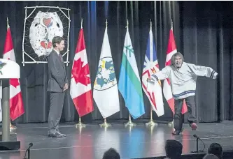  ?? ANDREWVAUG­HAN/ THE CANADIAN PRESS ?? Prime Minister Justin Trudeau welcomes residentia­l survivor Toby Obed to the stage after delivering an apology on behalf of the Government of Canada to former students of the Newfoundla­nd and Labrador Residentia­l Schools in Happy Valley-Goose Bay,...