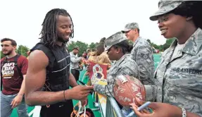  ?? MANUEL BALCE CENETA/AP ?? Josh Norman, signing autographs in May, said about his effort this week, “This is about the kids. So I never hesitated.”