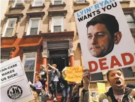  ?? Spencer Platt / Getty Images ?? Health care activists protest in front of a Harlem charter school before a visit by Speaker Paul Ryan, whose GOP House colleagues passed a contentiou­s health care bill this month.