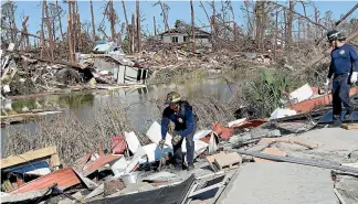  ?? AP ?? Miami firefighte­rs search for survivors in Mexico Beach, which bore the brunt of Hurricane Michael’s fury when the storm made landfall in the Florida Panhandle.