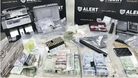  ??  ?? The Alberta Law Enforcemen­t Response Teams police team released this photo Friday showing drugs, guns and parapherna­lia seized from seven Edmonton-area homes last month.