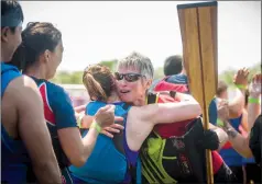  ?? Herald photo by Tijana Martin ?? Susan Graham hugs some of the other competitor­s after racing in the 16th annual ATB Financial Lethbridge Rotary Dragon Boat Festival at Henderson Lake on Sunday. @TMartinHer­ald