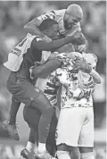  ?? AFP VIA GETTY IMAGES ?? U.S. teammates celebrate at the end of Tuesday’s group B match against Iran in Doha, Qatar.