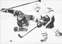  ?? HANNAH FOSLIEN THE ASSOCIATED PRESS ?? Minnesota’s Ryan Suter, left, watches as Leafs’ Zach Hyman takes the puck in the third period Saturday, depositing it in the empty net..