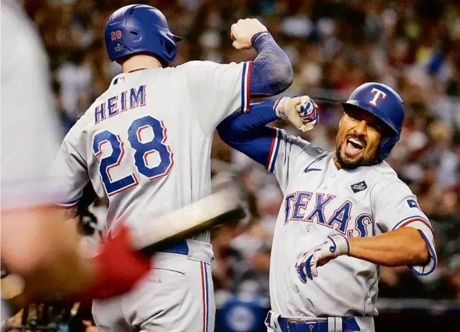  ?? BRYNN ANDERSON/ASSOCIATED PRESS ?? Marcus Semien celebrates with Rangers teammate Jonah Heim after his three-run homer in the third inning gave Texas a 10-0 lead in Game 4.