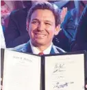  ?? FILE ?? Ron DeSantis holds up a newly signed bill banning abortions in Florida after 15 weeks at a news conference on April 14. Last week, a middle-school-aged victim of incest was forced to flee the state in order to obtain an abortion.