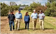  ??  ?? Vice President Mike Pence, his wife Karen Pence and Secretary of Agricultur­e Sonny Perdue talk with Rob and Eric Cohen, owners of the Pecan Ridge Plantation in Bainbridge on Tuesday. The Cohens lost 800 acres of pecan crops to Hurricane Michael.