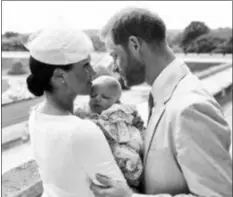  ?? CHRIS ALLERTON/©SUSSEXROYA­L VIA AP ?? This is an official christenin­g photo released by the Duke and Duchess of Sussex on Saturday, showing Britain’s Prince Harry, right and Meghan, the Duchess of Sussex with their son Archie Harrison Mountbatte­n-Windsor at Windsor Castle with with the Rose Garden in the background, in Windsor, England.