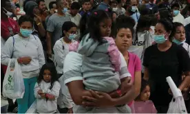  ?? Photograph: Paul Ratje/Reuters ?? Migrants wait in line before boarding buses to New York and Chicago at the Migrant Welcome Center managed by the city of El Paso, on 3 October.