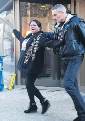  ?? JOHN WOODS / THE CANADIAN PRESS ?? Valentina Duck, Tina Fontaine’s mother, yells at reporters after a jury delivered a not-guilty verdict Thursday in the second-degree murder trial of Raymond Cormier.