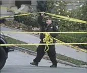  ?? Eric Risberg Associated Press ?? AN OFFICER closes a street below Nancy Pelosi’s home in San Francisco after the attack in October.