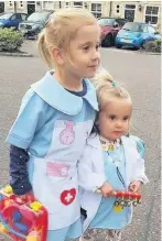  ??  ?? Lara Watts sent this pic of daughters Sienna, four, and Amara,1, from Rawtenstal­l showing support and clapping for our Carers