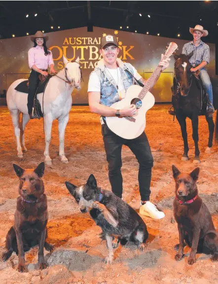  ?? Picture: GLENN HAMPDON ?? Outback Spectacula­r is partnering with Groundwate­r Country Music Festival. Country music star Casey Barnes with Outback stars Sabrina Durante (on Slider) and Caleb Degan (on River) with canine stars Red, Blue and Oi.