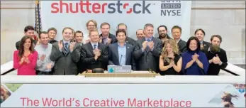  ??  ?? The staff of Shuttersto­ck celebrate after the company listed on the New York Stock Exchange in 2012.