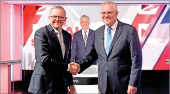  ?? ?? Morrison (right) and Albanese shake hands at the final leaders’ debate of the 2022 federal election campaign at Seven Network Studios in Sydney. — AFP photo