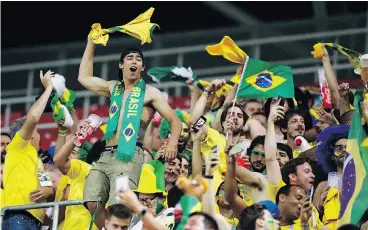  ?? VICTOR R. CAIVANO / THE ASSOCIATED PRESS ?? Brazil’s supporters celebrate the end of the group stage at the World Cup. “We don’t live off of expectatio­ns,” Brazilian coach Titi said post-game. “We live off reality.”