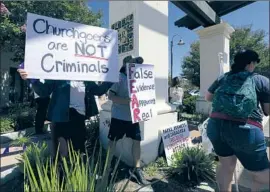  ??  ?? SHERIFF’S DEPUTIES addressed “minor scuff les” in the crowd at the Ventura County church, which has held indoor services despite a restrainin­g order.