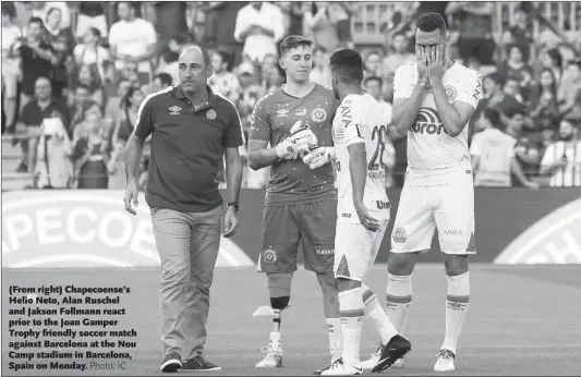  ?? Photo: IC ?? ( From right) Chapecoens­e’s Helio Neto, Alan Ruschel and Jakson Follmann react prior to the Joan Gamper Trophy friendly soccer match against Barcelona at the Nou Camp stadium in Barcelona, Spain on Monday.