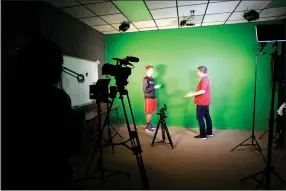  ?? Staff photograph by Flip Putthoff ?? Nick Coble (left) and Trenton Walker act out a scene recently in a broadcasti­ng class at Pea Ridge Manufactur­ing and Business Academy at Pea Ridge High School.