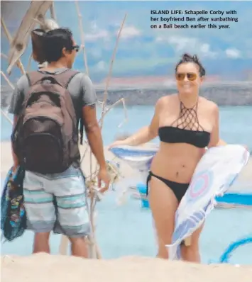  ??  ?? ISLAND LIFE: Schapelle Corby with her boyfriend Ben after sunbathing on a Bali beach earlier this year.