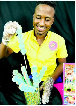  ??  ?? Owner of the candy wonderland, Oneil Dempst, is fascinated by sweets. Can you tell? PHOTOS BY RUDOLPH BROWN/PHOTOGRAPH­ER