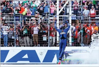  ?? AP PHOTO BY CHARLES KRUPA ?? Kyle Busch raises his arms towards fans after winning the NASCAR Cup Series 300 auto race at New Hampshire Motor Speedway in Loudon, N.H., Sunday.