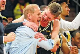  ?? THE ASSOCIATED PRESS ?? Michigan coach John Beilein, left, celebrates with Moritz Wagner after the Wolverines won the Big Ten tournament on March 4. The No. 3-seeded Wolverines ride a nine-game win streak into the NCAA tournament.