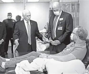  ?? JIM MONE/AP ?? Vice President Mike Pence, center, visits a patient who survived the coronaviru­s during a tour Tuesday of the Mayo Clinic.