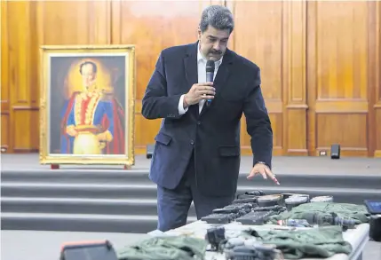  ?? REUTERS ?? Venezuela’s President Nicolas Maduro shows military equipment during a meeting with the Bolivarian armed forces at Miraflores Palace in Caracas, Venezuela on Monday.