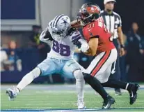  ?? FILE ?? Cowboys receiver CeeDee Lamb is swarmed by safety Antoine Winfield Jr. after a second-half catch during a 19-3 loss in the season opener last week.