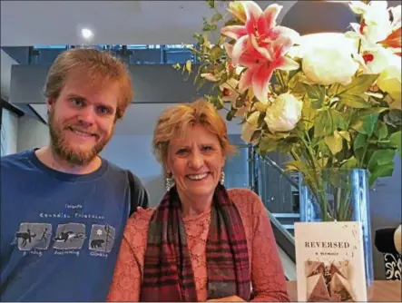  ?? PHOTO PROVIDED. ?? Author Lois Letchford of Green Island and her son Nicholas Letchford smile with the book about their experience­s.