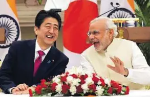  ?? AFP ?? Lighter moment Prime Minister Narendra Modi (right) shares a joke with Japan’s Prime Minister Shinzo Abe before the signing of agreements at Hyderabad House in New Delhi yesterday.