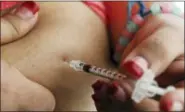  ?? REED SAXON — THE ASSOCIATED PRESS FILE ?? In this file photo, a woman diagnosed with diabetes gives herself an injection of insulin at her home in the Los Angeles suburb of Commerce.