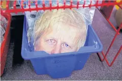  ??  ?? BOXED UP: A mask depicting PM Boris Johnson is seen at a “Perfect Parties” shop, amid the coronaviru­s disease, in Leighton Buzzard, UK, on Wednesday.