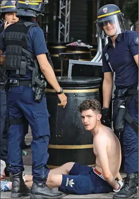  ??  ?? Held: Police arrested fans last night, ahead of tonight’s England game