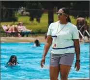  ?? (AP/Michael Conroy) ?? Pool manager Ashley Ford walks the pool deck June 17 at the Douglass Park pool.