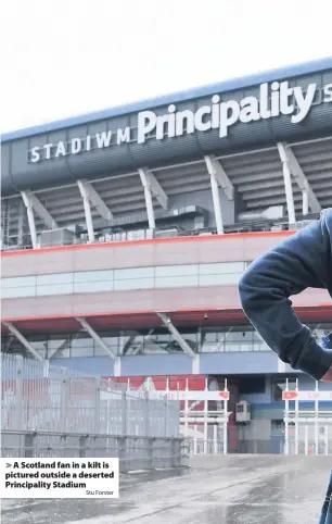  ?? Forster ?? > A Scotland fan in a kilt is pictured outside a deserted Principali­ty StadiumStu