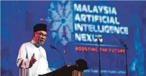  ?? PIC BY MOHAMAD SHAHRIL BADRI SAALI ?? Prime Minister Datuk Seri Anwar Ibrahim speaking at the launch of the Malaysia Artificial Intelligen­ce Nexus at the World Trade Centre in Kuala Lumpur yesterday.