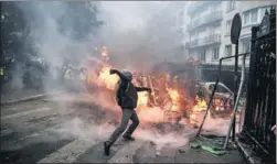  ?? AFP ?? ■ A protester throws a projectile at riot police during a protest of Yellow vests, a symbol of French drivers, against high diesel taxes and living costs, in Paris on Saturday. At least 400 people were arrested and more than 100 injured in the protest, the worst riots since 1968. &gt;&gt;P12