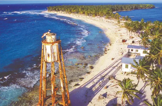  ?? DANIEL WOOD ?? The crescent-shaped beach on Belize's Half Moon Caye can be seen from the lighthouse. This tranquil tropical retreat is a base for relaxation and blue-water exploratio­n.