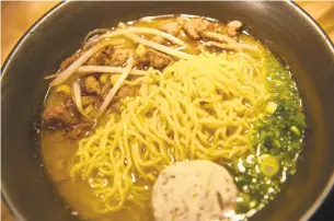  ??  ?? Baby Izakaya’s ramen is made with stir fried pork, corn, scallion butter and bean sprouts. Ramen is the perfect dish for cold weather days, a bowl full of warmth from within.