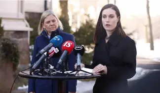  ?? ?? Finnish Prime Minister Sanna Marin, right, and her Swedish counterpar­t Magdalena Andersson speak to the media outside the Prime Minister's official residence Kesaranta