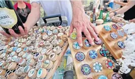  ?? JOHN MCCALL /SOUTH FLORIDA SUN SENTINEL ?? A variety of cork bottle stoppers are displayed during the Delray Affair in downtown Delray Beach in 2019.