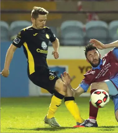  ??  ?? Fall guy - Drogheda United substitute Killian Brennan is brought to ground by Sligo Rovers’ Liam Martin and Craig