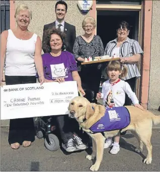  ?? Picture: David Wardle. ?? Margaret Sutherland presents Sally Hyder with the cheque for £10,000 with Dale Gormley (fundraiser for Canine Partner Scotland), Bo Gonsales, Violet Crawford and Natasha Sutherland with Harmony the dog.