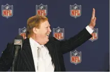  ?? Ross D. Franklin / Associated Press ?? Top, Andy Chose of Walnut Creek watches an NFL news conference on the Raiders’ move to Las Vegas at the Raider Image store in Oakland. Above, Raiders owner Mark Davis smiles after NFL owners voted to approve his team’s move.