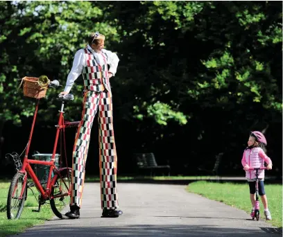  ??  ?? Stilt performer Thomas Trilby is back in the saddle riding his specially adapted bike around Pittville Park, Cheltenham