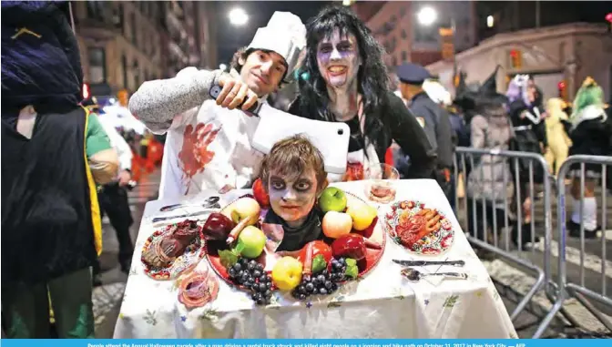  ??  ?? People attend the Annual Halloween parade after a man driving a rental truck struck and killed eight people on a jogging and bike path on October 31, 2017 in New York City.