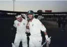  ?? Photograph: Laurence Griffiths/Getty Images ?? Nasser Hussain and Graham Thorpe celebrate a series win in the twilight dark of the third Test in Karachi in 2000.